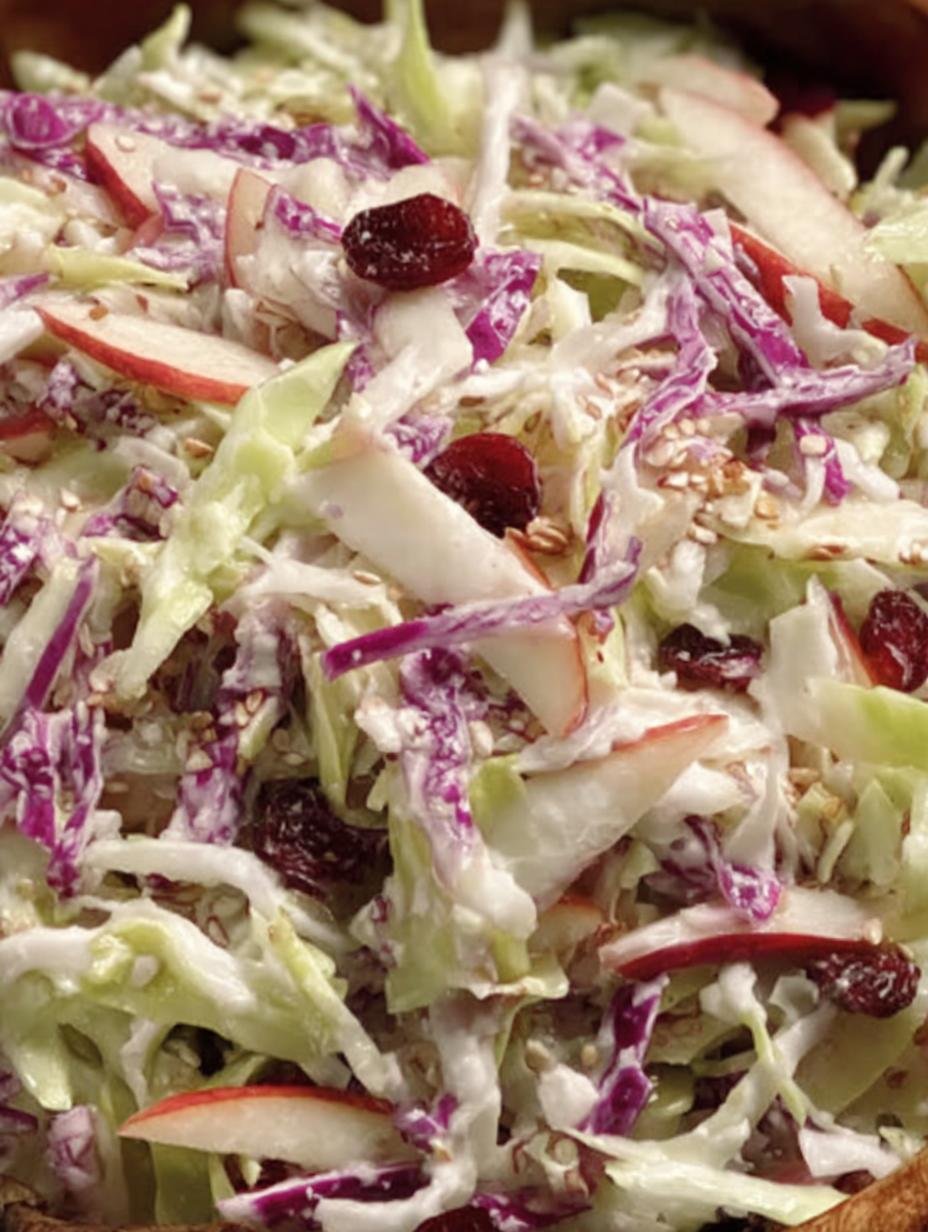 Close-up of Apple Cranberry Coleslaw showing crisp apples, cranberries, and cabbage